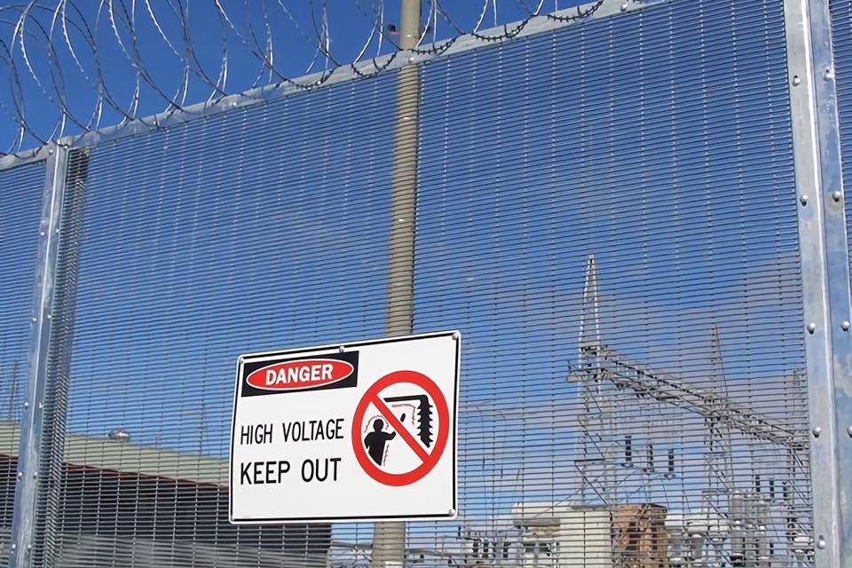 A high voltage warning sign is posted on the 358 high security fence to remind people danger.