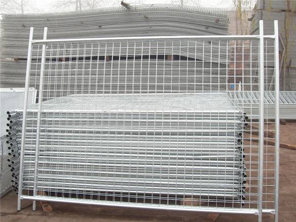 Two Australia temporary fence panels stand upright and other are placed on the ground.