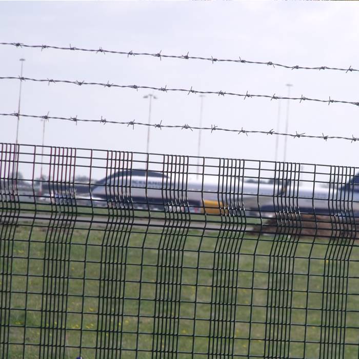 Three lines of barbed wires are installed on the top of airport fence.
