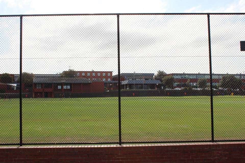 Chain link fences are installed along the sports field.