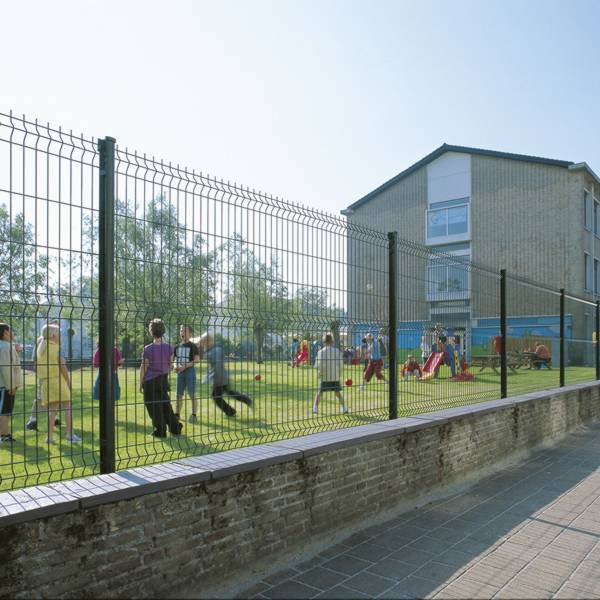 Many kids are playing around in the leisure park enclosed by curvy welded fence.