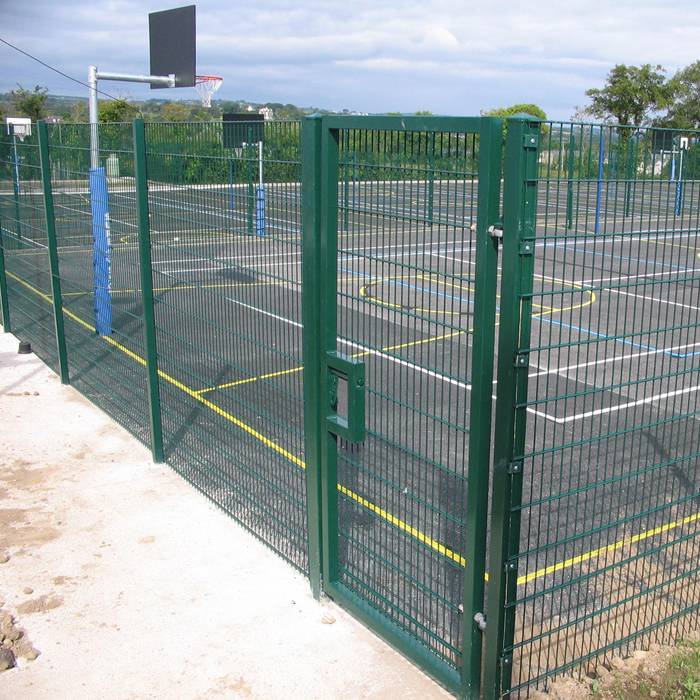 Double wire fence is used to create boundaries for basketball court.