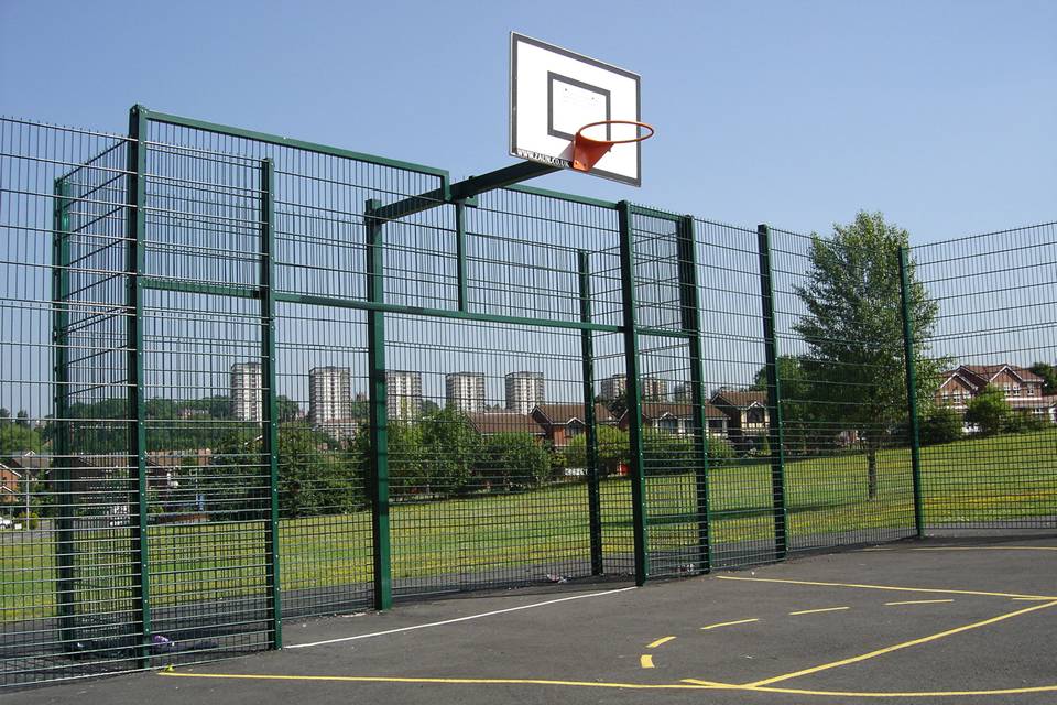 Double wire fences are installed around a basketball court.